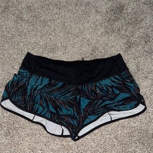 Lululemon 2.5” Black and Teal Patterned Hotty Hot Shorts